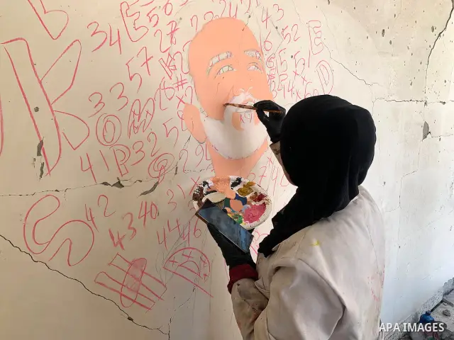 Palestinian artist Aseel Nasman creates artwork on the rubble of destroyed homes in the Gaza Strip on September 24, 2026. Nasman uses her art to portray international figures who have expressed support for Palestinians,...