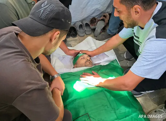 CAPTION: Palestinians mourn and attend the funeral of Hassan al-Batta, 42, who died from wounds sustained in an Israeli airstrike that targeted him in central Khan Younis, in the southern Gaza Strip, on September 25, 202...