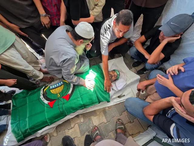 CAPTION: Palestinians mourn and attend the funeral of Hassan al-Batta, 42, who died from wounds sustained in an Israeli airstrike that targeted him in central Khan Younis, in the southern Gaza Strip, on September 25, 202...