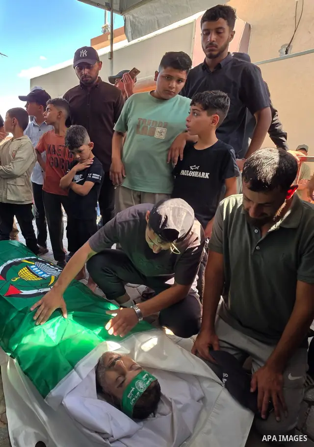 CAPTION: Palestinians mourn and attend the funeral of Hassan al-Batta, 42, who died from wounds sustained in an Israeli airstrike that targeted him in central Khan Younis, in the southern Gaza Strip, on September 25, 202...