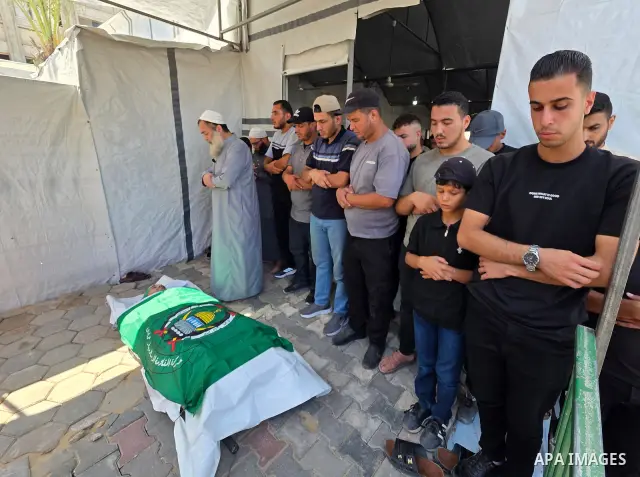 CAPTION: Palestinians mourn and attend the funeral of Hassan al-Batta, 42, who died from wounds sustained in an Israeli airstrike that targeted him in central Khan Younis, in the southern Gaza Strip, on September 25, 202...