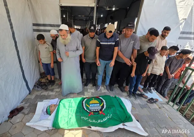 CAPTION: Palestinians mourn and attend the funeral of Hassan al-Batta, 42, who died from wounds sustained in an Israeli airstrike that targeted him in central Khan Younis, in the southern Gaza Strip, on September 25, 202...