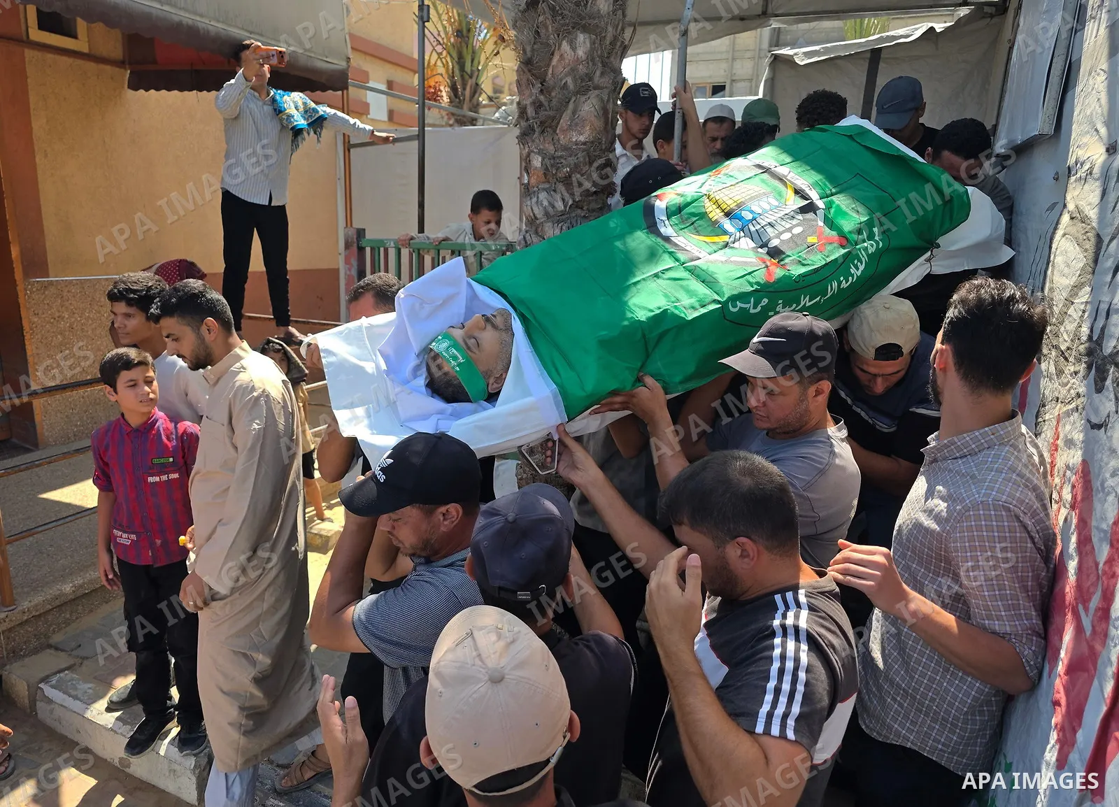 CAPTION: Palestinians mourn and attend the funeral of Hassan al-Batta, 42, who died from wounds sustained in an Israeli airstrike that targeted him in central Khan Younis, in the southern Gaza Strip, on September 25, 202...