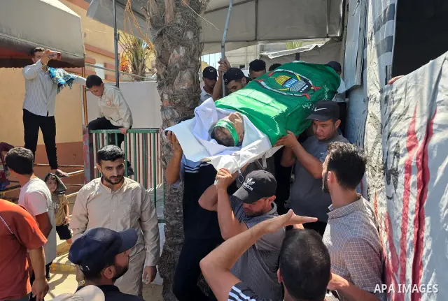 CAPTION: Palestinians mourn and attend the funeral of Hassan al-Batta, 42, who died from wounds sustained in an Israeli airstrike that targeted him in central Khan Younis, in the southern Gaza Strip, on September 25, 202...