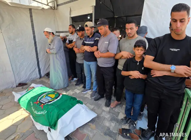 CAPTION: Palestinians mourn and attend the funeral of Hassan al-Batta, 42, who died from wounds sustained in an Israeli airstrike that targeted him in central Khan Younis, in the southern Gaza Strip, on September 25, 202...
