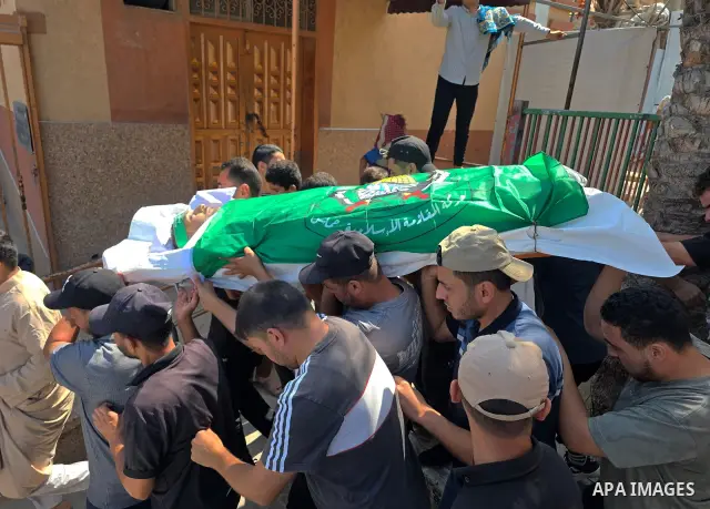 CAPTION: Palestinians mourn and attend the funeral of Hassan al-Batta, 42, who died from wounds sustained in an Israeli airstrike that targeted him in central Khan Younis, in the southern Gaza Strip, on September 25, 202...