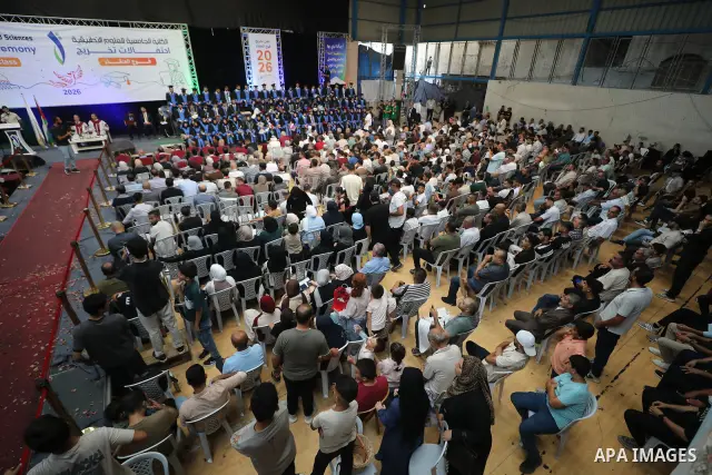 Palestinian students take part in a graduation ceremony for the University College of Applied Sciences at the Nuseirat refugee camp in the central Gaza Strip on September 24, 2026. The ceremony brought together graduates...