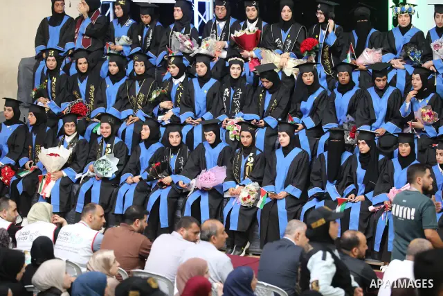 Palestinian students take part in a graduation ceremony for the University College of Applied Sciences at the Nuseirat refugee camp in the central Gaza Strip on September 24, 2026. The ceremony brought together graduates...