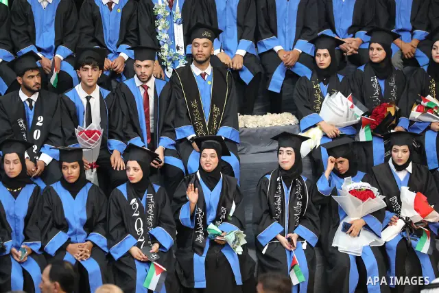 Palestinian students take part in a graduation ceremony for the University College of Applied Sciences at the Nuseirat refugee camp in the central Gaza Strip on September 24, 2026. The ceremony brought together graduates...