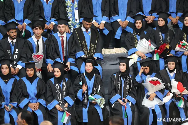 Palestinian students take part in a graduation ceremony for the University College of Applied Sciences at the Nuseirat refugee camp in the central Gaza Strip on September 24, 2026. The ceremony brought together graduates...