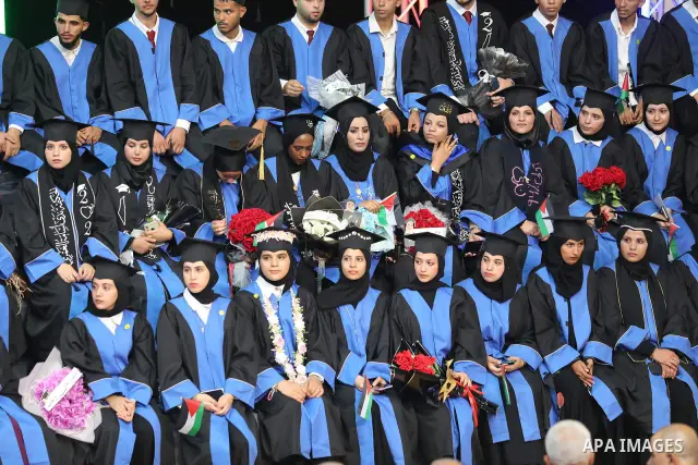 Palestinian students take part in a graduation ceremony for the University College of Applied Sciences at the Nuseirat refugee camp in the central Gaza Strip on September 24, 2026. The ceremony brought together graduates...