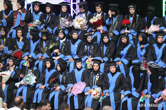 Palestinian students take part in a graduation ceremony for the University College of Applied Sciences at the Nuseirat refugee camp in the central Gaza Strip on September 24, 2026. The ceremony brought together graduates...