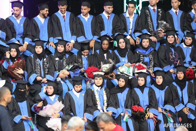 Palestinian students take part in a graduation ceremony for the University College of Applied Sciences at the Nuseirat refugee camp in the central Gaza Strip on September 24, 2026. The ceremony brought together graduates...