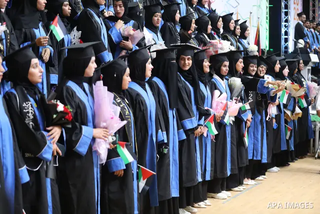 Palestinian students take part in a graduation ceremony for the University College of Applied Sciences at the Nuseirat refugee camp in the central Gaza Strip on September 24, 2026. The ceremony brought together graduates...
