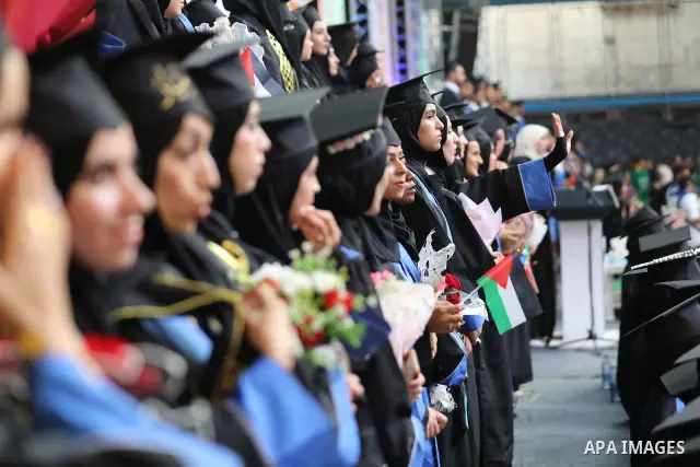 Palestinian students take part in a graduation ceremony for the University College of Applied Sciences at the Nuseirat refugee camp in the central Gaza Strip on September 24, 2026. The ceremony brought together graduates...