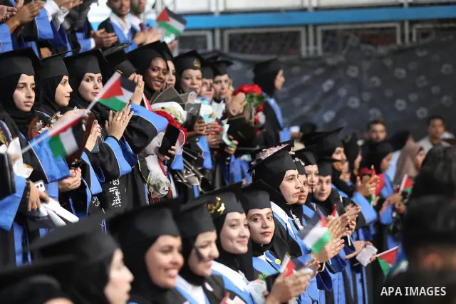 Palestinian students take part in a graduation ceremony for the University College of Applied Sciences at the Nuseirat refugee camp in the central Gaza Strip on September 24, 2026. The ceremony brought together graduates...