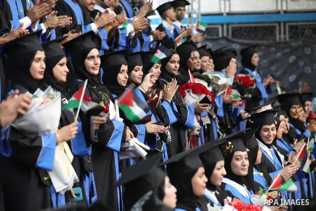 Palestinian students take part in a graduation ceremony for the University College of Applied Sciences at the Nuseirat refugee camp in the central Gaza Strip on September 24, 2026. The ceremony brought together graduates...